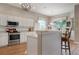 Kitchen island with seating and white cabinetry at 6043 Anvil Ave, Sarasota, FL 34243