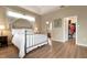 Spacious bedroom with a metal bed frame and ensuite bathroom access at 6043 Anvil Ave, Sarasota, FL 34243