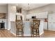 Kitchen island with breakfast bar and wooden stools at 6043 Anvil Ave, Sarasota, FL 34243