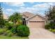 Single-Gathering home with a two-car garage and manicured lawn at 6043 Anvil Ave, Sarasota, FL 34243