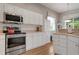 Spacious kitchen with stainless steel appliances and white cabinets at 6043 Anvil Ave, Sarasota, FL 34243