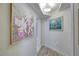 Bright hallway with artwork and wood-look flooring at 7329 Royal Palm Dr, New Port Richey, FL 34652