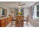 Bright dining room with wood table and chairs, plus a view to the backyard at 7329 Royal Palm Dr, New Port Richey, FL 34652