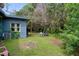 Private backyard with lush landscaping and a sitting area at 7329 Royal Palm Dr, New Port Richey, FL 34652