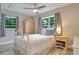 Bedroom with white metal bed frame and wood flooring at 7329 Royal Palm Dr, New Port Richey, FL 34652