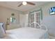 Bedroom with white metal bed frame and French doors at 7329 Royal Palm Dr, New Port Richey, FL 34652