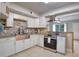 Modern kitchen featuring stainless steel appliances and stone backsplash at 7329 Royal Palm Dr, New Port Richey, FL 34652