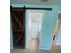 Bright bathroom features a decorative barn door entrance and stylish tile flooring at 2633 Daisy Dr, North Port, FL 34289