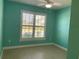 Well-lit bedroom with tile floors, a ceiling fan, and windows with plantation shutters at 2633 Daisy Dr, North Port, FL 34289