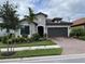 Charming single-story home with a well-manicured lawn and a two-car garage at 2633 Daisy Dr, North Port, FL 34289