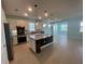 Large kitchen with stainless steel appliances, granite countertops, and an island at 2633 Daisy Dr, North Port, FL 34289