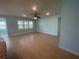 Spacious living room with tiled floors, ceiling fan and a large window at 2633 Daisy Dr, North Port, FL 34289