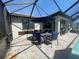 Covered patio area with table and seating for outdoor entertaining at 2633 Daisy Dr, North Port, FL 34289