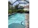 Enjoy this private screened-in pool surrounded by lush landscaping at 2633 Daisy Dr, North Port, FL 34289