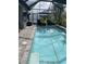 Relaxing screened-in pool with a waterfall feature and comfortable seating at 2633 Daisy Dr, North Port, FL 34289