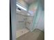 Tiled glass-enclosed shower with grab bars, bench, and a rain shower head at 2633 Daisy Dr, North Port, FL 34289