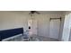 Well-lit bedroom featuring a view into the bathroom, ceiling fan and barn closet door at 3420 Ash St, Punta Gorda, FL 33950