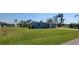 Charming single-story blue home with a well-maintained lawn and palm trees at 3420 Ash St, Punta Gorda, FL 33950
