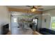 Open living room with a modern kitchen featuring stainless steel appliances and a glass dining table at 3420 Ash St, Punta Gorda, FL 33950