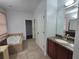 Bathroom with granite vanity, soaking tub, and shower at 3263 Sea Grape Dr, Hernando Beach, FL 34607