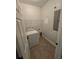 Laundry room with washer, dryer, and shelving at 3263 Sea Grape Dr, Hernando Beach, FL 34607