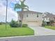 Two-story home with a garage and landscaping at 3263 Sea Grape Dr, Hernando Beach, FL 34607