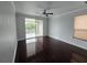 Bedroom with dark hardwood floors and access to balcony at 3263 Sea Grape Dr, Hernando Beach, FL 34607