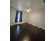 Spacious bedroom with dark floors and window at 3263 Sea Grape Dr, Hernando Beach, FL 34607