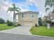 Tan two-story house with a two-car garage at 3263 Sea Grape Dr, Hernando Beach, FL 34607