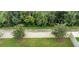 Aerial view of the backyard with a white vinyl fence and a vibrant green grass at 31510 Tansy Bnd, Wesley Chapel, FL 33545