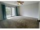 Spacious bedroom with carpet and sliding glass doors at 6583 River Run Blvd # 21005, Spring Hill, FL 34607