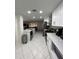 Modern kitchen with white cabinets, granite countertops and stainless steel appliances at 1359 Cambridge Dr, Venice, FL 34293