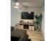 Comfortable living room featuring a fireplace and large TV at 1359 Cambridge Dr, Venice, FL 34293