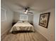 Bright bedroom with a king-size bed and wood-look floors at 1359 Cambridge Dr, Venice, FL 34293
