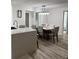 Modern dining area with large table, six chairs, and kitchen island at 1359 Cambridge Dr, Venice, FL 34293