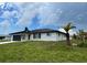 White brick home with black metal roof and landscaping at 1359 Cambridge Dr, Venice, FL 34293