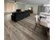 Open living area with L-shaped sectional and hardwood floors at 1359 Cambridge Dr, Venice, FL 34293