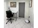 Bright home office features a standing desk and a door leading outside at 1359 Cambridge Dr, Venice, FL 34293
