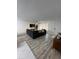 Spacious living area with L-shaped sofa and wood-look floors at 1359 Cambridge Dr, Venice, FL 34293