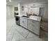White kitchen cabinets, quartz countertops, and an island at 1359 Cambridge Dr, Venice, FL 34293