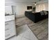 Spacious living area with L-shaped sectional sofa and hardwood floors at 1359 Cambridge Dr, Venice, FL 34293