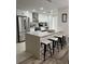 Modern kitchen with stainless steel appliances and an island with seating at 1359 Cambridge Dr, Venice, FL 34293