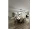 Bright dining room with a large table and modern light fixture at 1359 Cambridge Dr, Venice, FL 34293