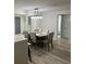 Bright dining room with a modern light fixture and seating for six at 1359 Cambridge Dr, Venice, FL 34293