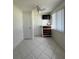 Cozy bedroom with tile flooring, a dresser, and a TV at 1359 Cambridge Dr, Venice, FL 34293
