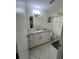 Updated bathroom with granite countertops and white cabinets at 1359 Cambridge Dr, Venice, FL 34293