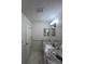 Double vanity bathroom with granite countertop and updated lighting at 1359 Cambridge Dr, Venice, FL 34293