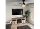 Living room with electric fireplace and large TV at 1359 Cambridge Dr, Venice, FL 34293