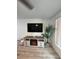 Living room with electric fireplace and large TV at 1359 Cambridge Dr, Venice, FL 34293
