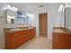 Double vanity bathroom with wood cabinets and tile floors at 510 Wideview Ave, Tarpon Springs, FL 34689